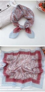 Close-up of vintage geometric print square scarf with delicate rolled edges and light blue fabric