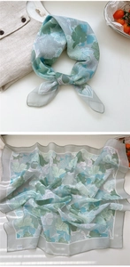 Detail view of floral silk scarf showing sheer chiffon fabric and elegant flower print