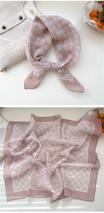 Detailed view of pink floral chiffon square scarf with white trim and delicate patterns