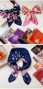 Detailed macro view of floral print silk scarves with premium satin texture and gloss