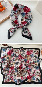 Detailed close-up of floral silk scarf with rose patterns and smooth satin texture