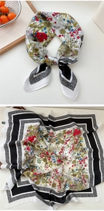Detailed view of floral silk scarf with colorful flower patterns and polka dot border