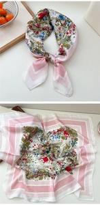 Macro detail of square floral silk scarf with pink borders and vibrant flower print