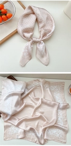 Detailed macro shot of champagne floral silk square scarf tied with elegant draping