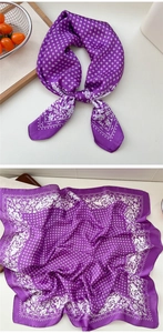 Detailed view of a purple silk-like scarf with floral patterns and geometric textures