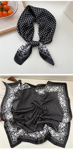 Close-up of black and white floral silk scarf with geometric patterns and white roses