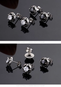 Detailed macro view of vintage titanium steel claw earrings with clear and black zircons