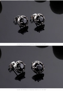 Close-up of vintage Gothic stud earrings with black round gemstone and silver petal claw setting