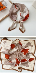 Detailed close-up of a floral silk scarf with rose patterns in brown and red tones