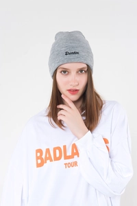 Close-up of gray knitted beanie featuring black Drunken embroidered letters on front