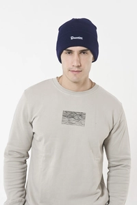 Detail of navy knit beanie with white Drunken embroidery and wave print sweatshirt
