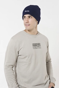 Detail of navy knit beanie with Drunken white embroidery and grey sweatshirt texture