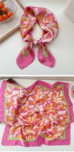 Detailed macro view of pink floral silk scarf featuring smooth satin texture and elegant floral print