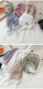 Detailed macro view of lace trim edges on soft linen cotton triangle scarves in various colors