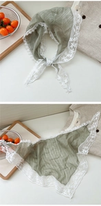 Macro detail of elegant sage green lace trim and semi-transparent gauze texture