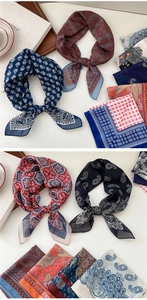 Detail showing various silk scarves with floral and geometric patterns on a table