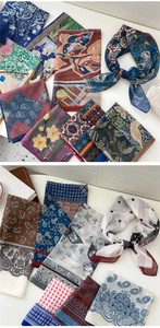 Close-up of assorted silk square scarves with paisley, floral, and geometric patterns