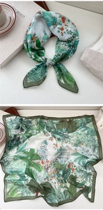 Detailed close-up of tropical silk scarf featuring palm leaves and classical architecture