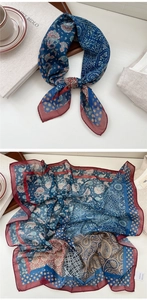 Detail of navy and red paisley silk-feel scarf showing rich texture and fine stitching