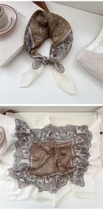 Detail of silk square scarf featuring vintage brown paisley print tied as a necktie knot