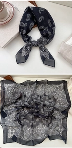Close-up of black and white paisley pattern silk scarf with fine texture and print detail