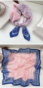 Detail view of the red and navy square silk scarf with floral prints and geometric borders