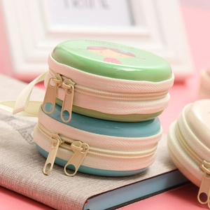 Detail of round tinplate coin purses with cute cartoon girl prints and dual zippers