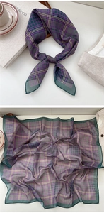 Detailed view of checkered silk scarf with purple and green plaid patterns and rolled hem