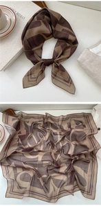 Detailed view of earth-tone geometric pattern scarf draped and laid flat for styling