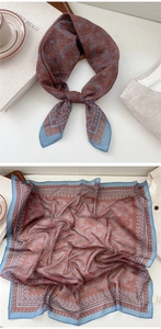 Detail of vintage paisley silk scarf featuring red and blue patterns for versatile styling