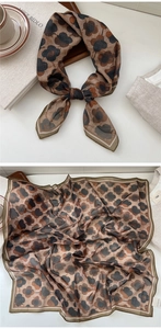 Detail of a vintage floral square silk scarf with brown earthy tones and delicate edges