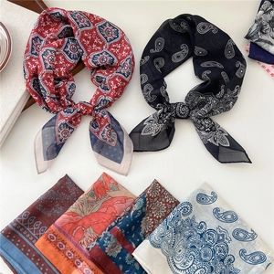 Elegant collection of printed square silk scarves featuring floral and geometric patterns