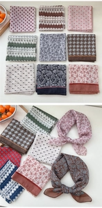Close-up of various floral and geometric patterns on soft cotton linen small square scarves
