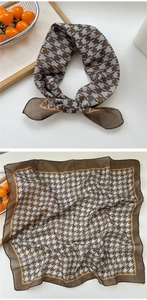 Detail of soft houndstooth square scarf in brown and blue with yellow piped edges