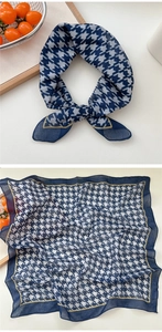 Detail of navy and white houndstooth scarf with elegant yellow borders in a lifestyle setting