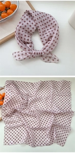 Detail of light purple floral cotton scarf showing fine rolled edges and daisy pattern