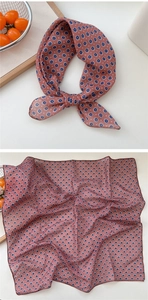 Close-up of lightweight floral square scarf featuring intricate blue flower patterns