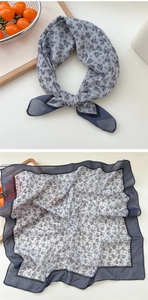 Detail view of breathable grey blue floral square scarf with elegant hand-drawn patterns