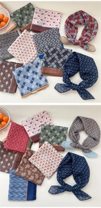 Flat lay of multiple cotton-linen square scarves with vintage floral and paisley patterns