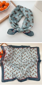 Detailed close-up of light blue cotton linen square scarf with geometric check patterns