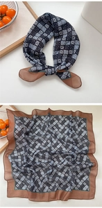 Detail of navy and grey checkered cotton linen scarf with floral patterns and brown border