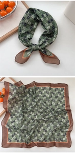 Detail of green geometric pattern cotton linen square scarf with orange contrast borders