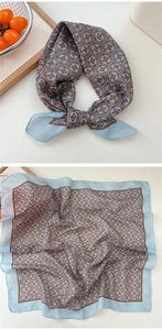 Detail of light blue floral cotton linen scarf showing texture and vintage print patterns