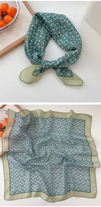 Detail of green cotton linen square scarf with vintage white floral pattern and rolled edge