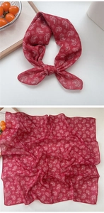 Detail of red paisley cotton linen small square scarf with fine hem and knotted style