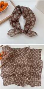 Detail of brown paisley cotton linen scarf showing soft fabric texture and patterns