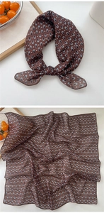 Detailed macro view of retro brown cotton linen scarf with geometric oval patterns