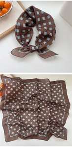 Detailed macro view of smooth silk-like texture and blue geometric patterns on a brown scarf