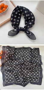 Detail view of cotton-linen neckerchief with black checkered pattern and logo design