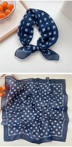 Detailed view of dark blue square cotton linen scarf with elegant geometric white logo print